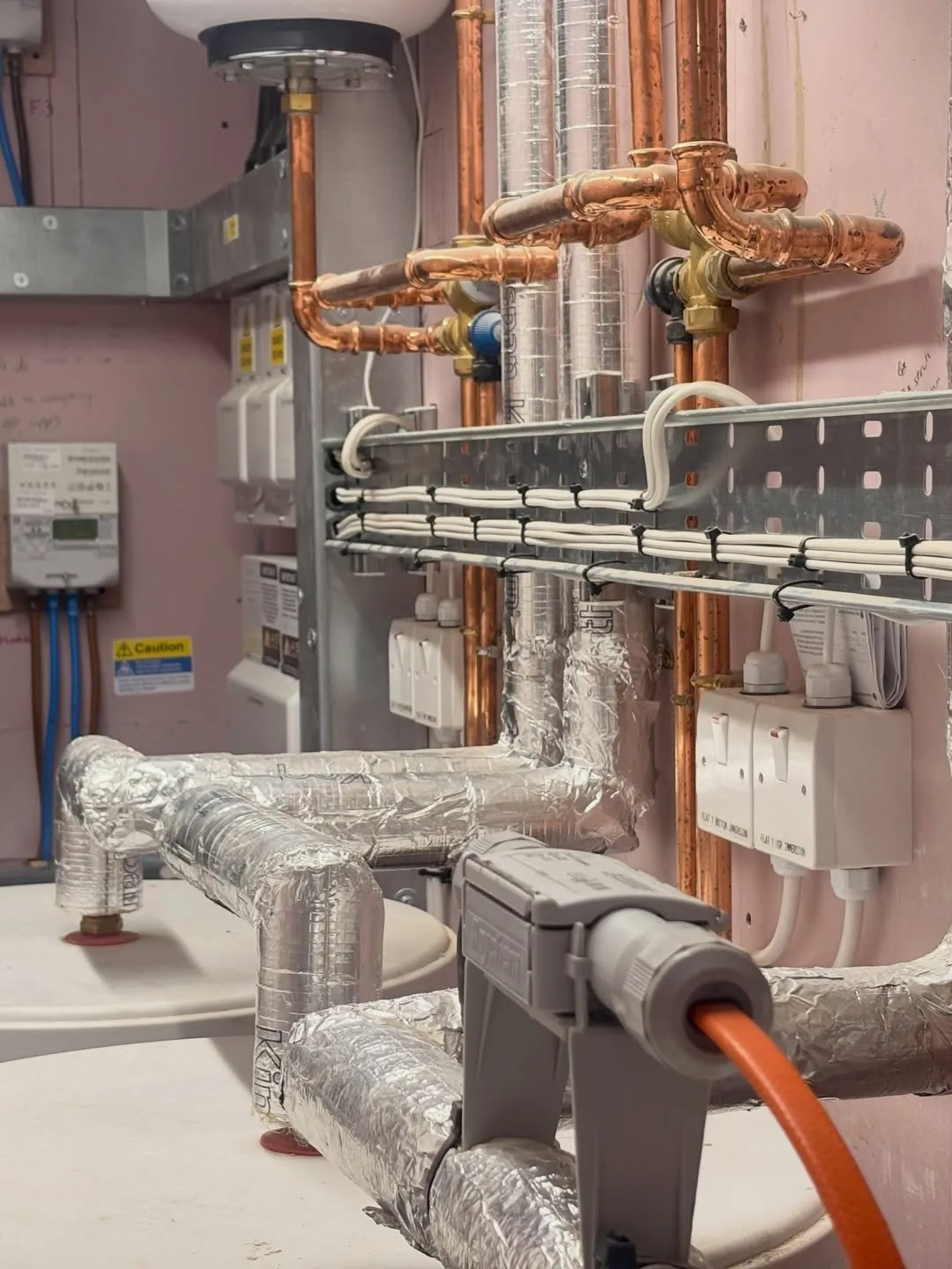 Cable tray and containment carrying cables in a plant room