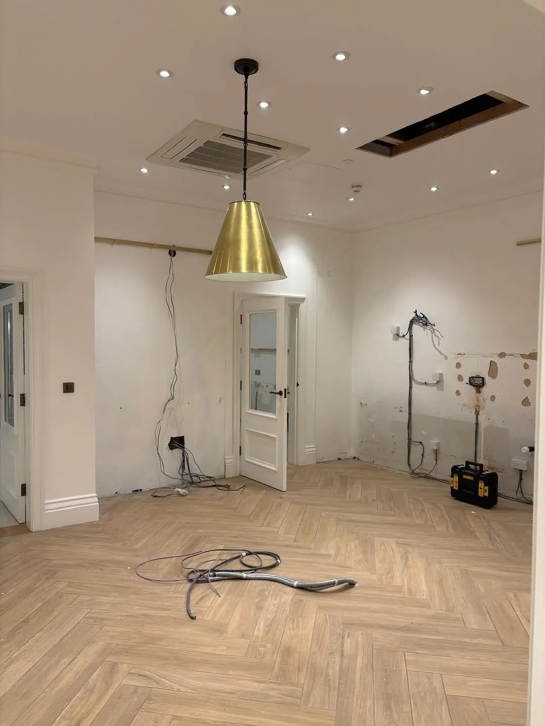 Refurbished room with a new pendant light and second-fix wiring