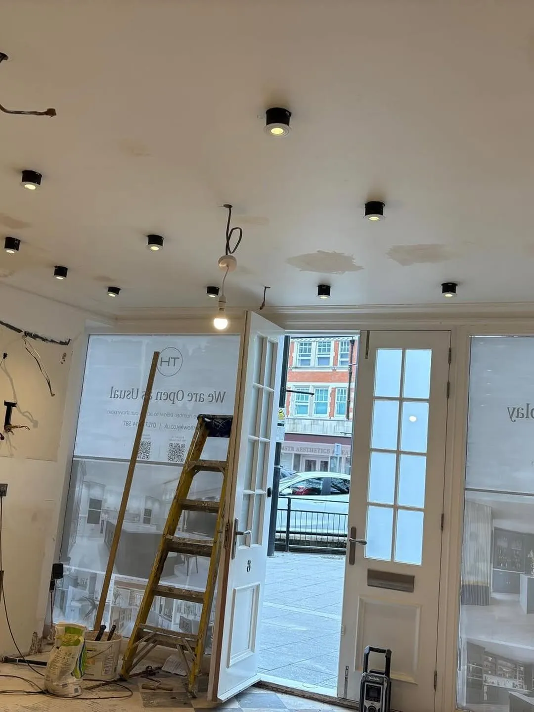 Showroom refurbishment with new surface-mounted downlights and first-fix wiring