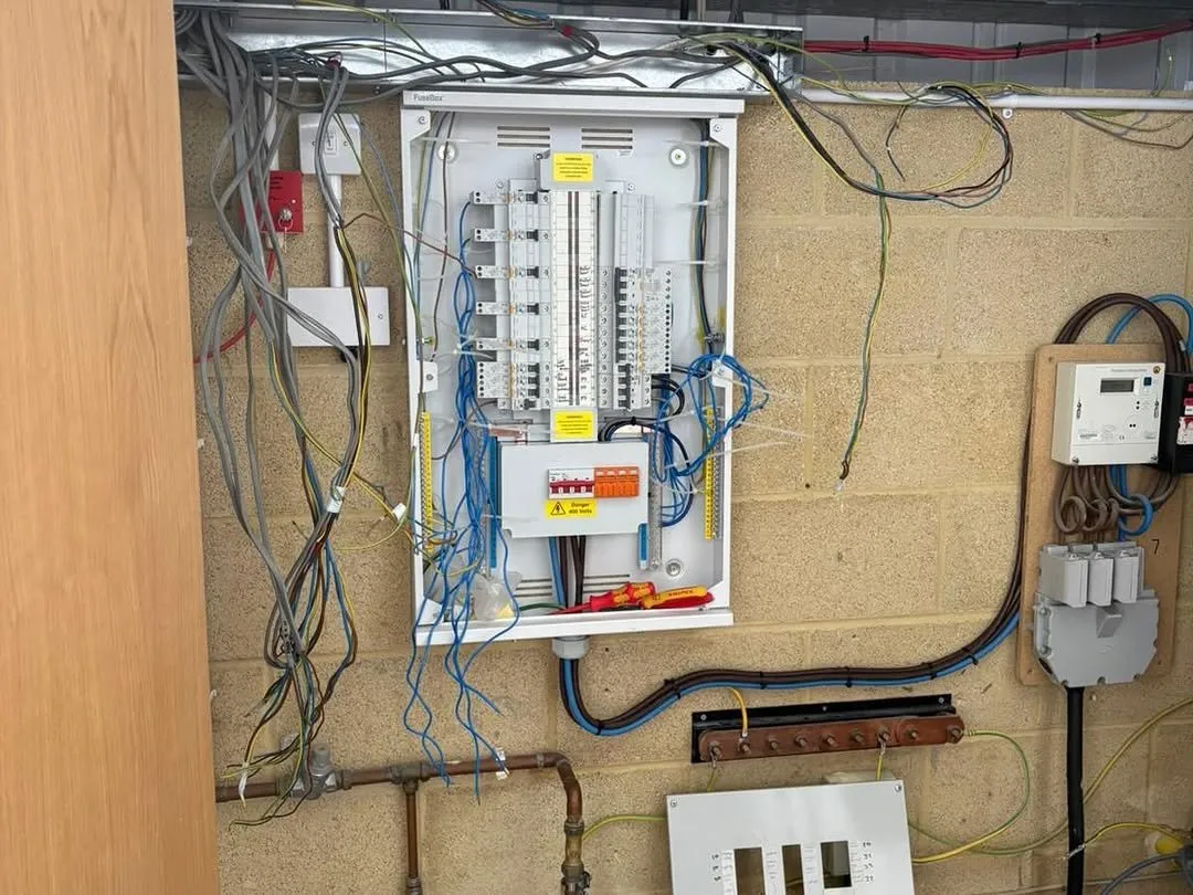 New three-phase distribution board being installed in an industrial unit
